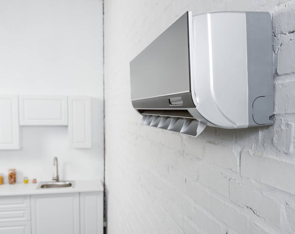close-up-shot-of-air-conditioner-hanging-on-white--ZEZDHLM